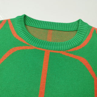 Encolure de blouse en maille verte à motifs géométriques orange, col rond côtelé.