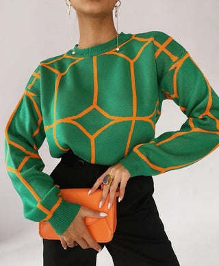 Blouse en maille verte à motifs géométriques orange, col rond côtelé, manches longues.
