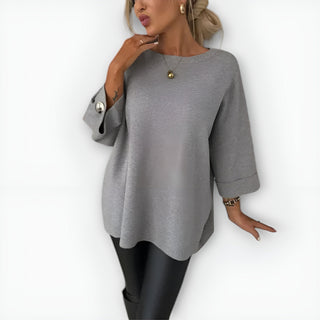 Pull femme oversize gris à col rond, manches trois-quarts et poignets boutonnés