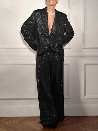 Veste longue en sequins noirs, coupe oversize, revers à encolure et manches amples.