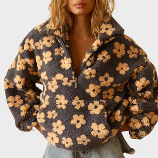 Pull quart de zip en polaire gris foncé à fleurs jaunes, zip demi-hauteur.
