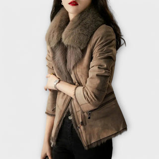 Manteau suédé taupe avec col en fourrure, poignets fourrés et fermeture zippée.