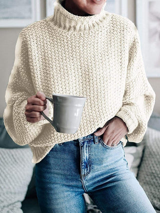 Pull en tricot épais beige clair, col montant côtelé, manches longues, mailles texturées