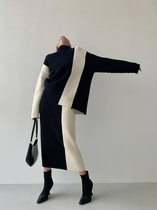 Ensemble jupe et blouse noire avec empiècements écru, manches longues, jupe mi-longue.