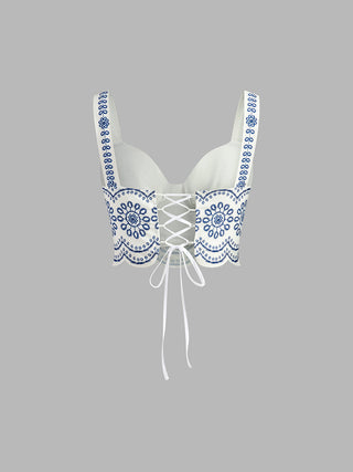 Bustier en lin brodé bleu, empiècement central avec laçage, bretelles à motifs