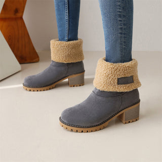 Bottes mi-mollet gris foncé à col en fausse fourrure beige, talon bloc et semelle crantée.