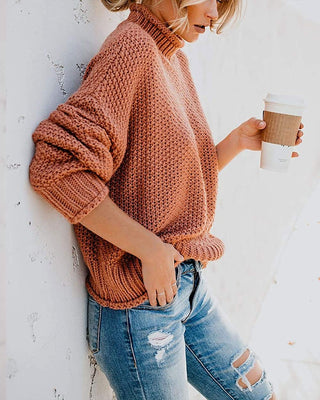 Pull en tricot épais orange, col montant côtelé, manches bouffantes, maille dense