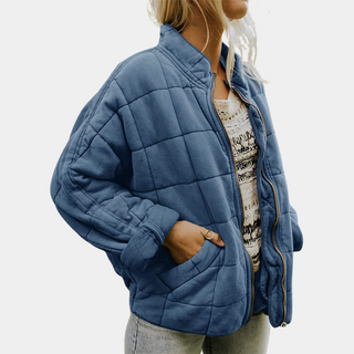 Manteau matelassé bleu à fermeture éclair, col montant et poches latérales
