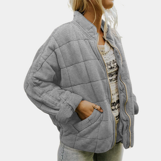Manteau matelassé gris à fermeture éclair, col montant et poches latérales