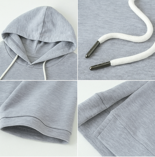 Hoodie à manches courtes gris, capuche et cordons blancs, détails du tissu.