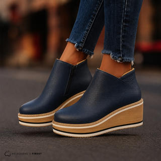 Bottes à talon compensé cuir bleu marine, tige mi-mollet, zip latéral.