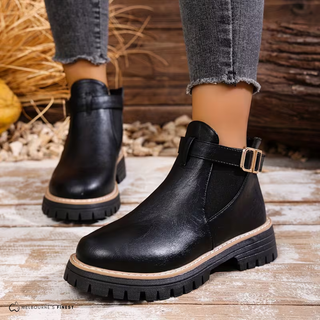 Bottines orthopédiques noires avec bride à boucle et semelle épaisse crantée