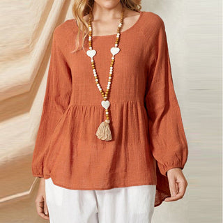 Blouse peplum orange à manches bouffantes, encolure ronde, bas évasé