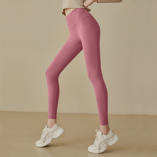 Leggings taille haute rose, coupe près du corps, coutures galbantes et jambes ajustées