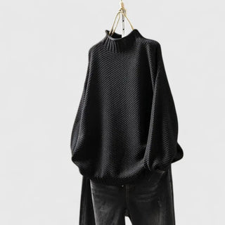 Pull femme col montant texturé noir, coupe ample et manches chauve-souris