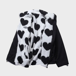 Veste réversible Manuela avec extérieur noir et polaire blanche à cœurs, zip devant