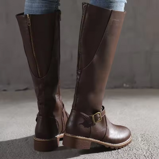 Bottes cuissardes marron foncé à talon plat, fermeture zippée et boucle.