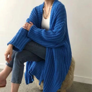 Manteau long bleu en maille côtelée, col châle, manches longues, ourlet à franges.
