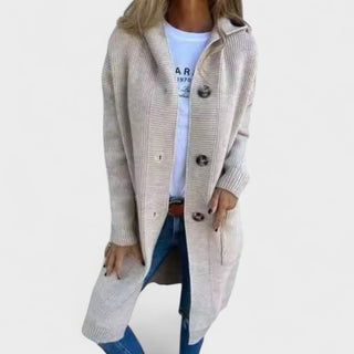 Manteau long beige clair, col châle, boutonnage sur l’avant, poches latérales