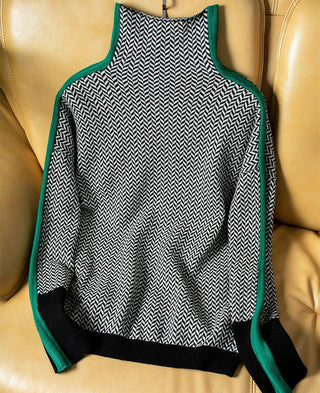 Blouse à col montant, imprimé chevrons noir et blanc, finitions vertes, manches longues