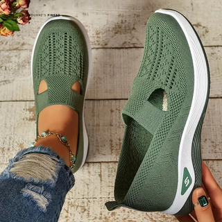 Chaussures orthopédiques vertes en maille respirante, semelles blanches et renfort latéral.