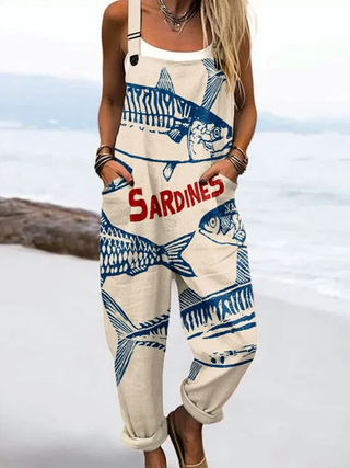 Combinaison à bretelles imprimée poissons, fond beige et motif bleu avec texte rouge
