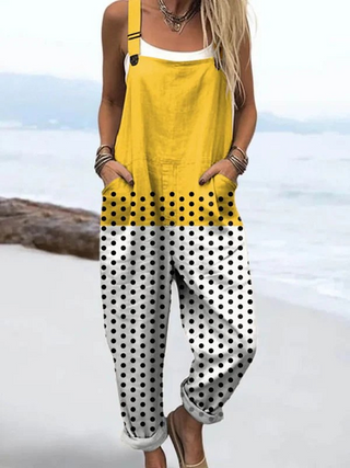 Combinaison sans manches à bretelles, haut jaune et jambes blanches à pois noirs.