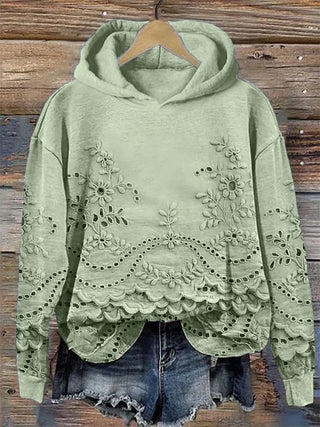 Sweat à capuche vert, broderie florale et ourlet festonné