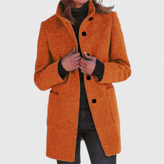 Manteau classique en laine orange, fermeture boutonnée, col ouvert, poches plaquées.