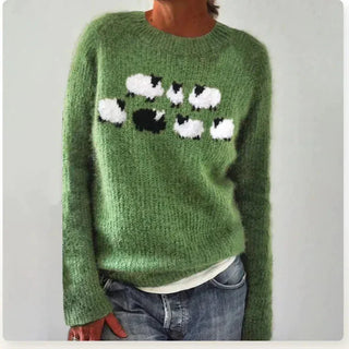Pull femme vert, encolure ronde large, motif animaux en relief blanc et noir.