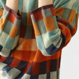 Col montant et bordures côtelées d’un pull en laine à carreaux multicolores
