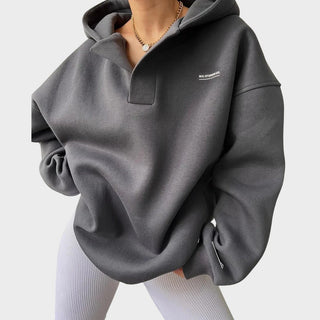 Sweat à capuche gris chic, col demi-zip et poche kangourou, capuche à finitions côtelées.