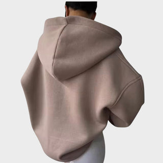 Sweat à capuche beige rosé au dos, capuche volumineuse et poche kangourou, manches longues.