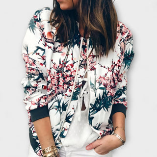 Veste bomber blanche à motif floral, fermeture zippée, poignets et bas côtelés.