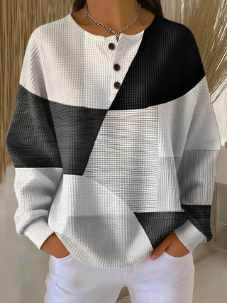 Pull henley en tricot waffle, blocs noir et blanc, manches longues boutonnées